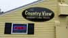 Building mounted sign with vinyl graphics